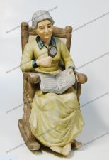 Скульптура "Старушка с книгой в кресле-качалке". Конец XIX в. Германия. Фарфор (бисквит). Тонировка. Эмаль.